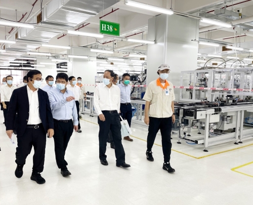 企業負責人向陳選堯（左二）、陳岸明（左三）介紹電機生產車間和資料化管理模式